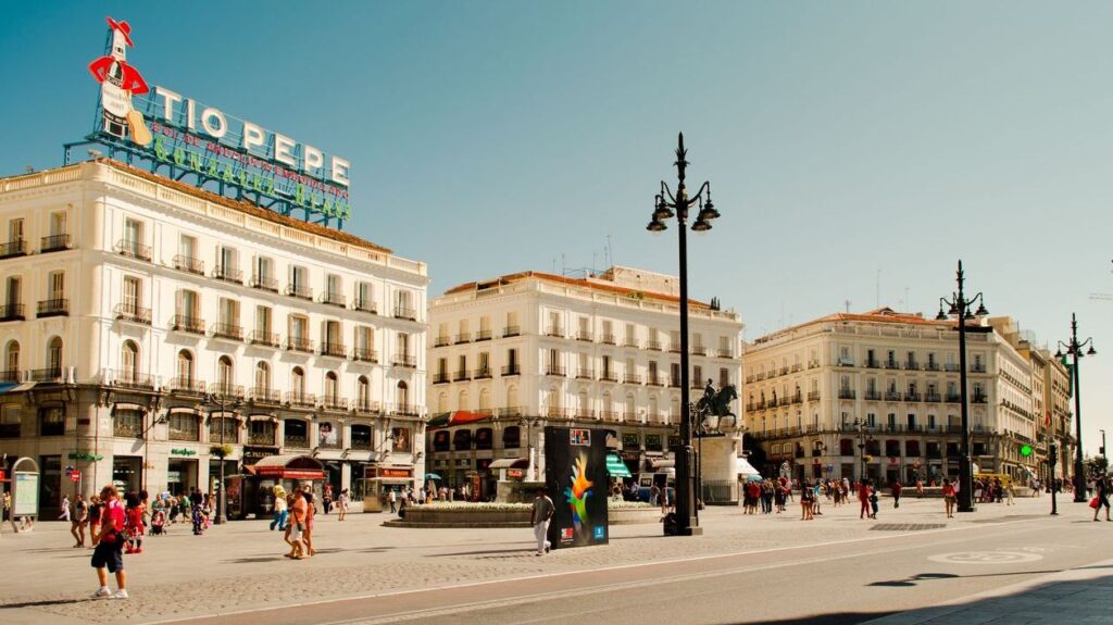 MADRID, SPAIN - AUGUST 5, 2014: Architecture of Madrid. Unknown tourists at square Puerta del Sol.